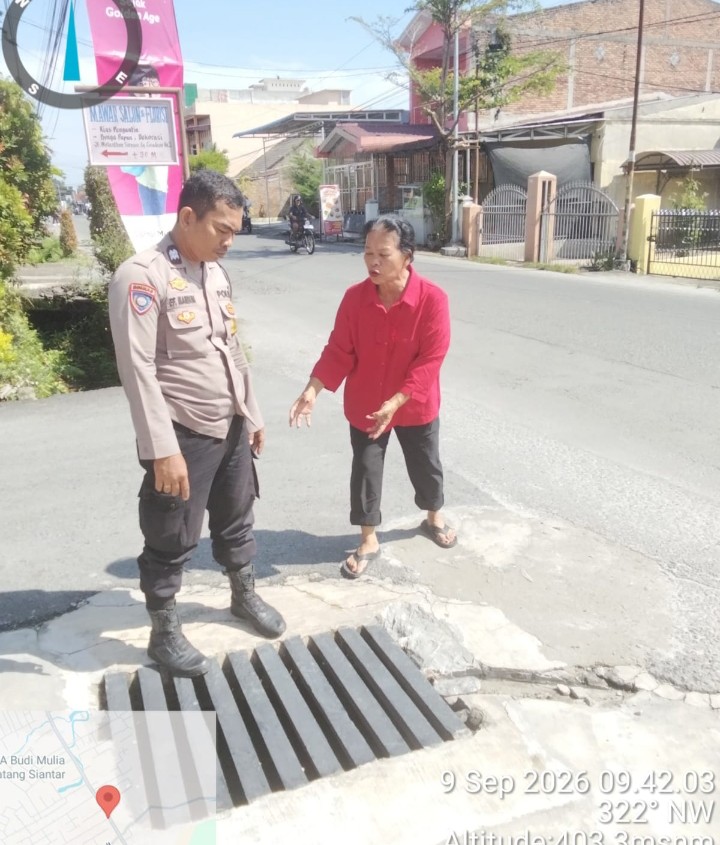 Bhabinkamtibmas Polsek Siantar Marihat Cek Saluran Air di Gang Cisadane.